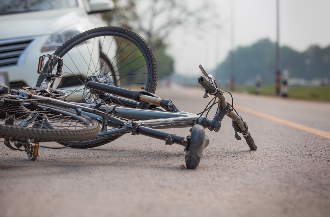 bicycle on the road in front of a vehicle after a bicycle accident.
